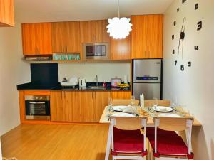 a kitchen with a table with chairs and a dining room at The Elevated Abode - ComfyCosy 1-br at The Loop in Cagayan de Oro