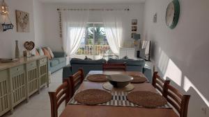 a kitchen and dining room with a table and chairs at Luz Ocean Club Apartments in Luz