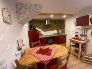 a kitchen and dining room with a table and chairs at Ferienhaus Göbel´s gute Stube in Wirfus