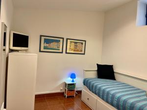a small bedroom with a bed and a tv at Julias Pateo in Carcavelos