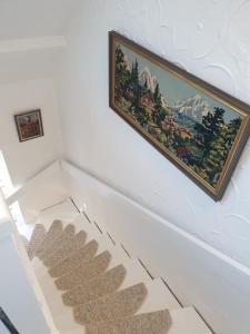 a painting hanging on a wall next to a staircase at Ferienwohnung Wiskow in Goslar in Goslar