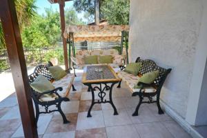 a patio with a table and chairs and a couch at Agrielia in Gaios