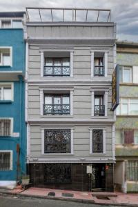 a tall white building with a sign on it at Istanbul Taksim MARİDA SUIT in Istanbul