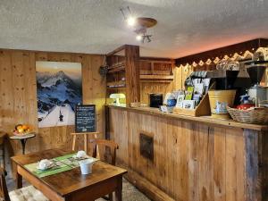 a restaurant with a counter and a table in a room at Hotel Funivia in Courmayeur