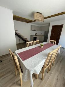 a dining room with a white table and chairs at Casa Zorilor in Şugag