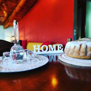 a table with a bottle of wine and a cake at Kristi's Homes - "Beautiful Attic" in Dimitsana in Dhimitsana