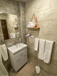 ツァグカゾールにあるKechi House Apartment 132の洗面台、鏡、タオルを備えたバスルーム