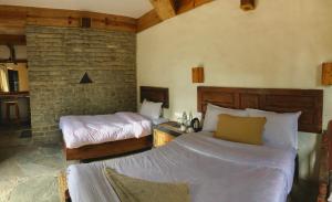 Postelja oz. postelje v sobi nastanitve Bhanjyang Village Lodge