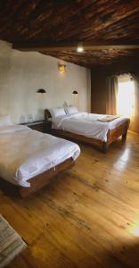 Postelja oz. postelje v sobi nastanitve Bhanjyang Village Lodge