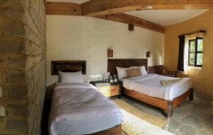 Postelja oz. postelje v sobi nastanitve Bhanjyang Village Lodge