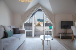 a living room with a couch and a large window at Mavi Avlu - Main Square Old Town in Antalya