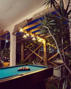 a pool table in front of a patio with a fence at Villa Sea View in Saint-Leu
