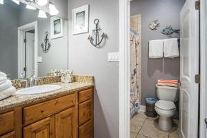 a bathroom with a sink and a toilet at 7 Bedroom Home STEPS TO THE BEACH With 4 Patios and Pool! Sleeps 20 in Port Aransas