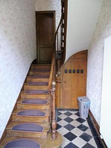 a staircase in a room with a checkered floor at Gîte Chateau baie de somme 10 a 12 personnes in Mons-Boubert