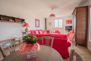 a living room with a red couch and a table at U Paradisu - Villa 10/12 pers avec piscine privée in Alata