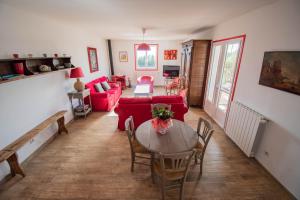 a living room with a red couch and a table at U Paradisu - Villa 10/12 pers avec piscine privée in Alata