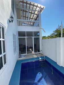 a house with a swimming pool next to a building at Casa los Titos in Manzanillo
