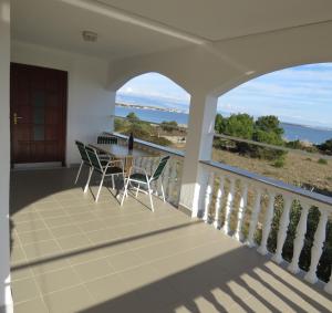 a view from the balcony of a house with a table and chairs at Apartman Vir Gogo br 5 in Vir