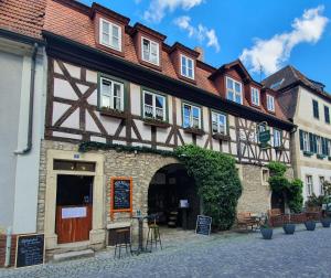 a building on a street in a town at Hotel & Restaurant Sonnenhöfle in Sommerhausen