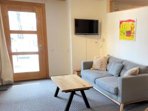 uma sala de estar com um sofá e uma mesa de centro em Ferienwohnung CASA URSIN Val Lumnezia em Lumbrein