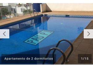 a swimming pool with two chairs next to it at Pau-pi in Oliva