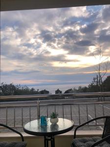 a table on a balcony with a view of the ocean at Apartman Ivešić in Makarska