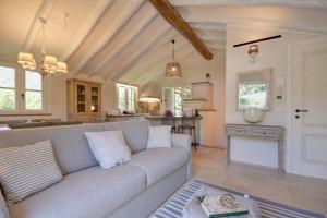 a living room with a couch and a kitchen at I Giardini di Camogli - VILLA RUMANIN, garden&pool in Camogli +53 photos