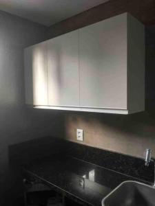 a kitchen with a sink and a white cabinet at Ilusion flat Ponta Negra in Natal