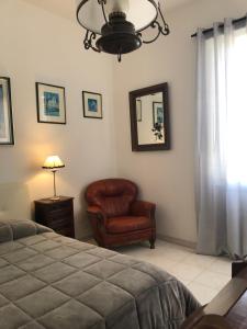 a living room with a couch, chair and lamp at B&B Maison Rosetta IUN-E4948 in Nuoro