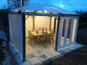 a gazebo with a table and chairs at The Annex at Middle Filham in Ivybridge