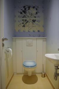 bagno con servizi igienici blu e lavandino di La Maison de L Artiste - Chambres d'hôtes à Verdun - avec jacuzzi a Verdun-sur-Meuse