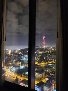 a view of the television tower from a window at Serviced Luxurious 3+1 in Address Emaar Square in Istanbul