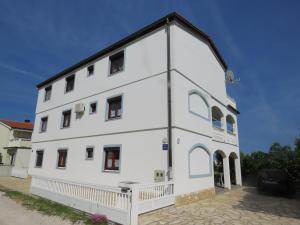 a white building with a black roof at Apartman Vir Gogo br 5 in Vir +2 photos
