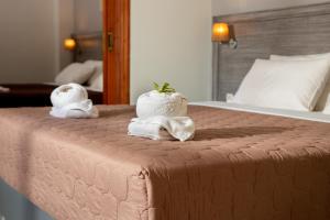 two towels on a bed in a hotel room at Anna Katerina Apartments in Plataniás