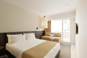 Postel nebo postele na pokoji v ubytování Hotel Cupidon