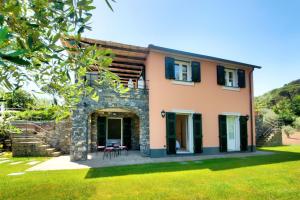 a house with a stone and black shutters at I Giardini di Camogli - VILLA RUMANIN, garden&pool in Camogli