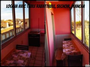 een restaurant met 2 tafels in een kamer met ramen bij appartement du pecheur in Valras-Plage
