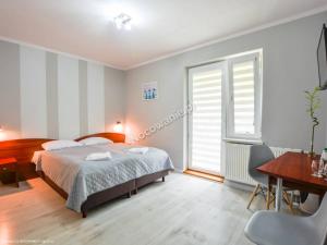 Łóżko lub łóżka w pokoju w obiekcie Ośrodek Wypoczynkowy Evita