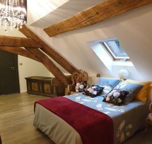 a bedroom with a bed in a attic at Maison Bélénos in Nevy-sur-Seille
