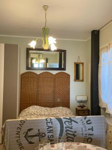 a bedroom with a bed and a mirror at Casa del sasso in Bergeggi