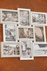a group of photographs in white frames on a table at B&B Pozzorosso in Vasto