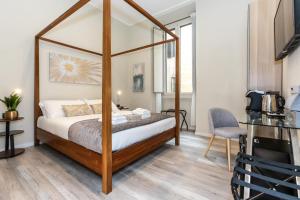 a bedroom with a canopy bed in a room at Suites 44 - Guesthouse close to Vaticano, San Pietro, Castel Sant'angelo in Rome