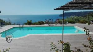 a swimming pool with a view of the ocean at Oroverde in Bergeggi