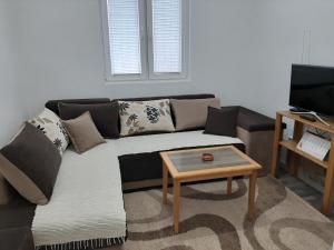 a living room with a couch and a coffee table at Vikendica RTANJ in Rtanj