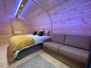 a bedroom with a bed and a couch at Bryn Glamping in Coychurch