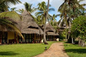 a resort with palm trees and a pathway at Ocean Paradise Resort & Spa in Pwani Mchangani