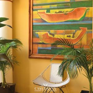 a painting of boats on a wall with plants at Hotel Casa Danna in Colima