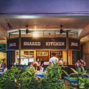 a restaurant with people sitting at tables in front of it at Pak-Up Hostel in Krabi town