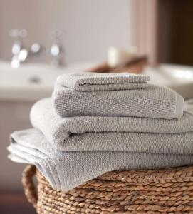 a stack of towels sitting on top of a basket at La Rufina B&B in Mendoza