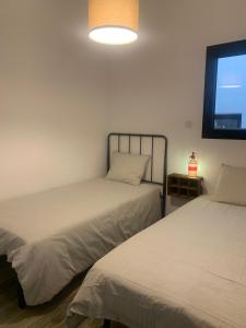 Postel nebo postele na pokoji v ubytování CAN MARTINEZ Calella Beach Boutique Apartment